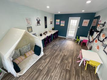 Childrens playroom with colorful furniture and art wall