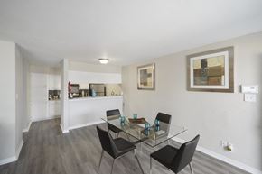 Houston apartment for rent - A dining room with a glass table and chairs.