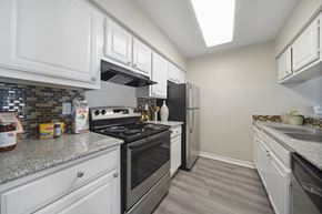 Houston apartment for rent - A kitchen with white cabinets and a stainless steel stove.