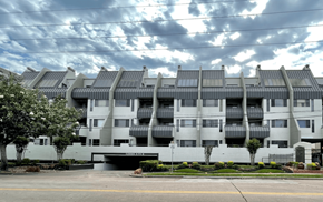 Houston apartment for rent - Modern apartment building with metal roofing and balconies at Augusta Court Apartments, Houston, TX 77057