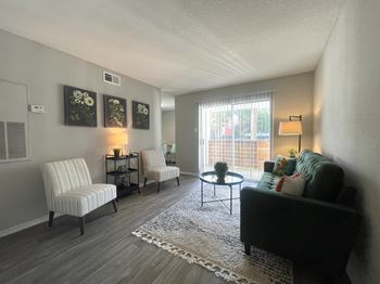 Living room with striped chairs and teal sofa