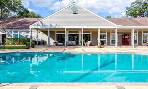 Houston apartment for rent - A house with a pool in front.