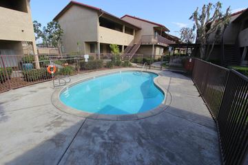 Fontana apartment for rent - A small pool in a courtyard surrounded by a fence.