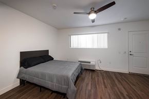 Stanton apartment for rent - A bedroom with a bed, a ceiling fan, and a window with blinds.