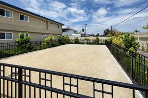 Stanton apartment for rent - A black fence surrounds a sandy area.