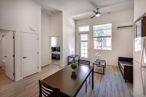 San Juan Capistrano apartment for rent - A modern dining room with a wooden table and chairs.