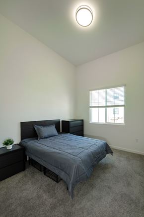 San Juan Capistrano apartment for rent - A bedroom with a bed, nightstand, and window.