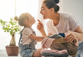 Fontana apartment for rent - A woman and a child are sitting together, with the woman holding a basket of clothes.