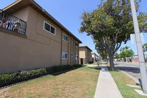 Garden Grove apartment for rent - A row of houses with a tree in front of them.