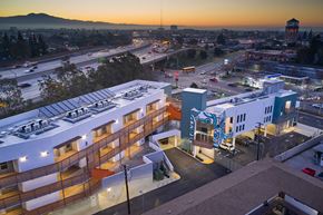 Santa Ana apartment for rent - A sunset view of a cityscape with a large building in the foreground.