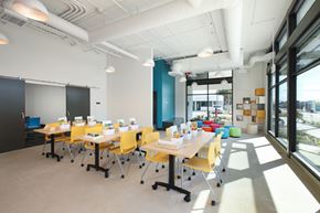 Santa Ana apartment for rent - A conference room with yellow chairs and white tables.