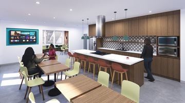 Costa Mesa apartment for rent - A woman is sitting at a table in a modern kitchen.