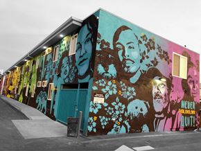 Santa Ana townhouse for rent - A wall of graffiti art featuring faces and flowers.