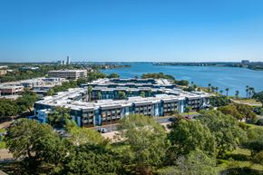 Houston apartment for rent - an aerial view of a building with a lake in the background