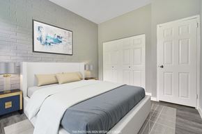 Maple Shade apartment for rent - A bedroom with a large bed and a painting on the wall.