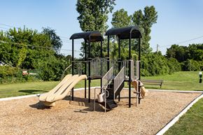 Columbus apartment for rent - A playground with a slide, swings, and a climbing frame.