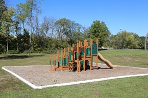 Columbus apartment for rent - A playground with a slide and a wooden structure.