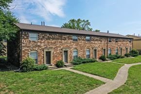 Columbus apartment for rent - A brick building with a green lawn in front.