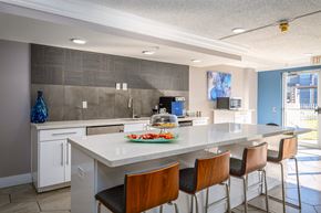 Houston apartment for rent - a kitchen with a large island and bar stools