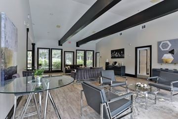Stone Mountain apartment for rent - A modern living room with a glass table and grey chairs.