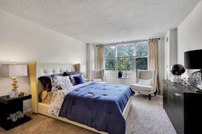 Cherry Hill apartment for rent - A bedroom with a large bed and a window with curtains.