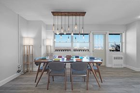 Asbury Park apartment for rent - A dining room with a table set for four and a view of the city.
