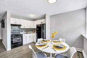 Maple Shade apartment for rent - A modern kitchen with a dining table set for two.