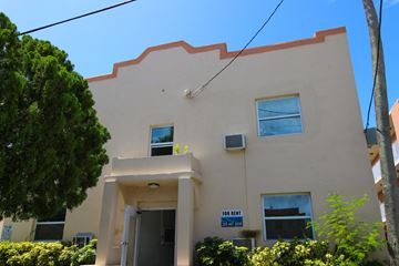 Miami apartment for rent - A two-story building with a "For Rent" sign in front.