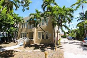 Miami apartment for rent - a house with a palm tree in front of it