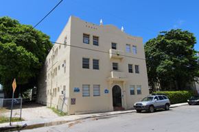 Miami apartment for rent - a building on the corner of a street with a car parked in front of it