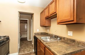 Columbus apartment for rent - A kitchen with a sink, stove, and cabinets.