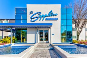 Houston apartment for rent - the exterior of the sap office building with pools and a blue and white sign