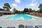 Chesterfield townhouse for rent - A large outdoor swimming pool surrounded by lounge chairs and trees at The Lawton Townhomes, Virginia, 23832