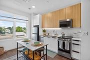 Allston apartment for rent - A kitchen with a table set for two with plates and glasses on it.