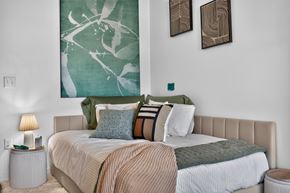 Allston apartment for rent - A bedroom with a large bed and two wall art pieces at The Indie in Allston.
