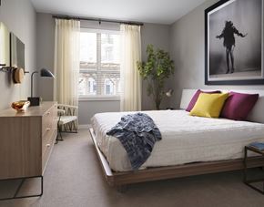 Worcester apartment for rent - A bedroom with a large bed and a painting on the wall.