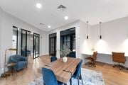 Middletown apartment for rent - A modern dining room with a wooden table and blue chairs.