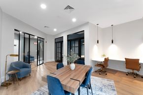 Middletown apartment for rent - A modern dining room with a wooden table and blue chairs.