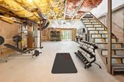 Shirley apartment for rent - A basement with gym equipment and a sliding door at Birchwood Hills, Shirley, MA.