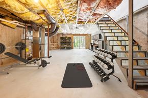 Shirley apartment for rent - A basement with gym equipment and a sliding door at Birchwood Hills, Shirley, MA.