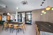 Allston apartment for rent - A modern dining room with a long table and chairs.
