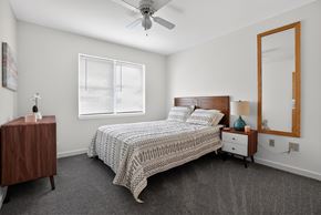Brunswick apartment for rent - A bedroom with a bed, nightstand, and a ceiling fan.