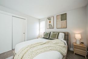 Chelmsford apartment for rent - A bedroom with a bed covered in a white blanket and pillows.