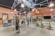 Glastonbury apartment for rent - a gym with weights and cardio equipment and a brick wall at The Tannery, Glastonbury