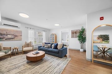 Brunswick apartment for rent - A living room with a blue couch and a wooden coffee table.