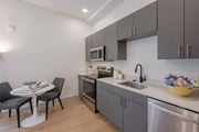 Kittery apartment for rent - A modern kitchen with a table and chairs at Seacoast Residences Apartments, Maine
