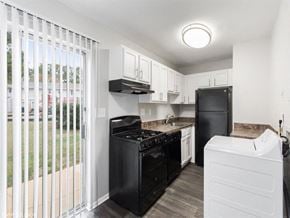 Chesterfield townhouse for rent - a kitchen with a black stove top oven next to a refrigerator at The Lawton Townhomes, Chesterfield ,Virginia, 23832