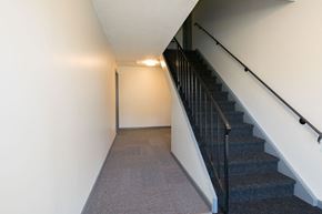 Fall River apartment for rent - A staircase with a black railing and a grey carpet. at South Winds Apartments, Fall River, 02720