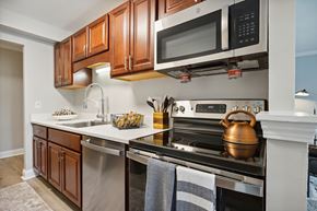 Danbury apartment for rent - A kitchen with a stove top oven and a microwave above it.