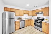 Hooksett apartment for rent - A modern kitchen with wooden cabinets and stainless steel appliances at Windsor Terrace, Hooksett, NH